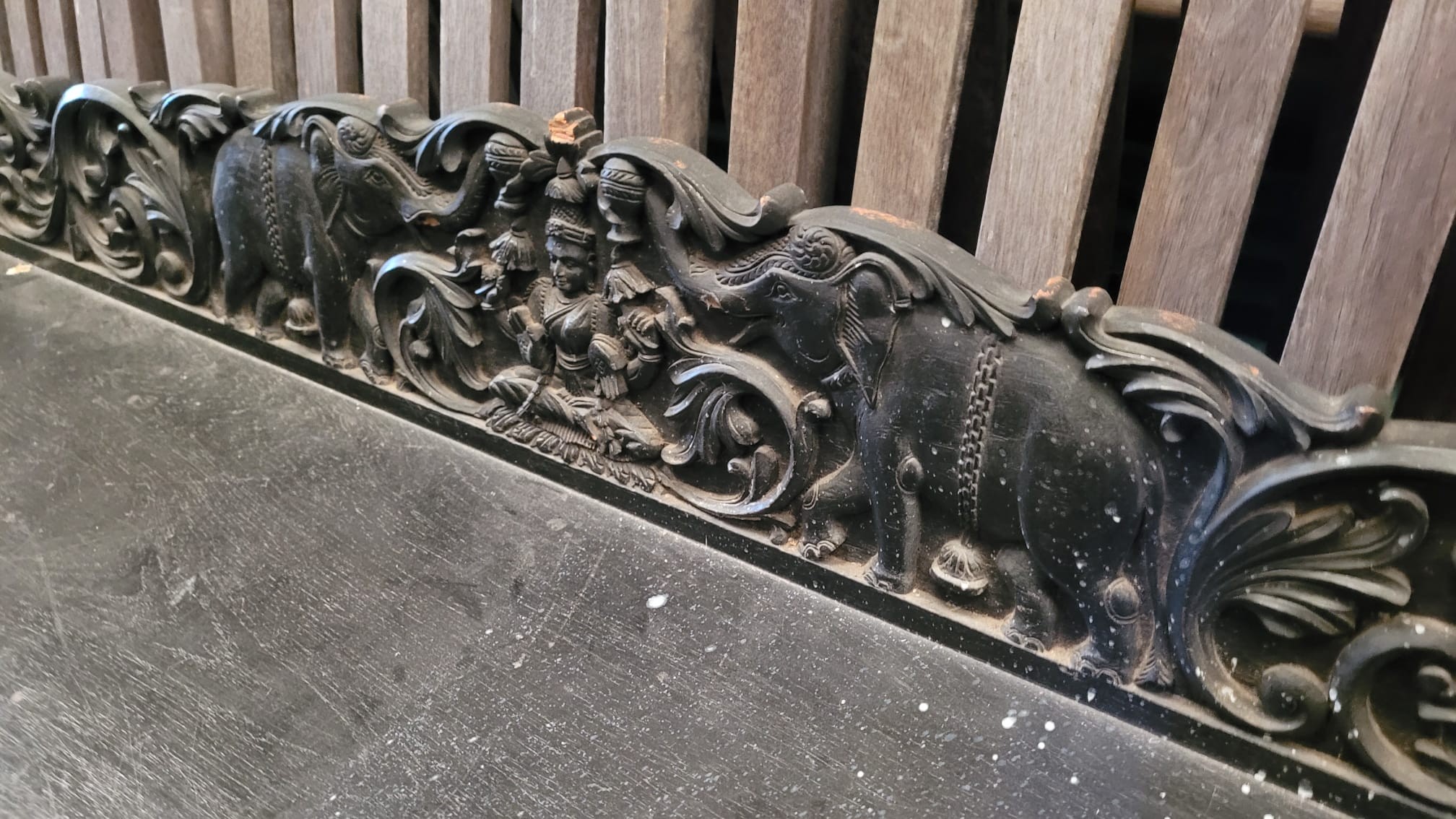 An Indian carved ebonised oak bracket, length 152cm, depth 36cm, height 21cm